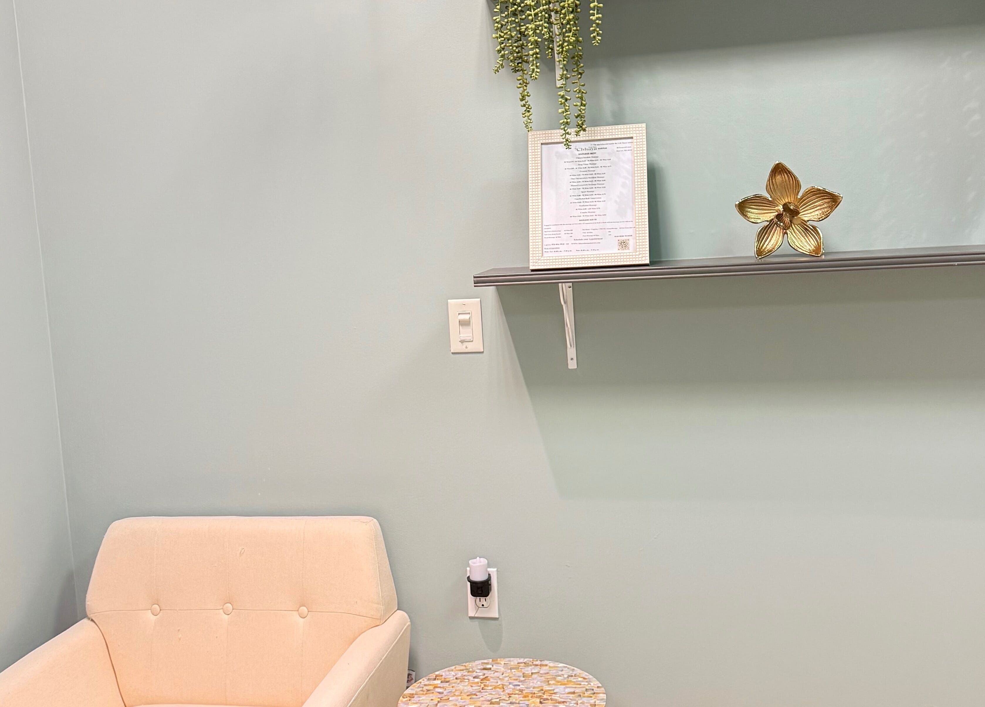 Cozy waiting area at Chhaya Thai Spa Danvers with a chair, shelf, and decor in Danvers, Massachusetts, US.