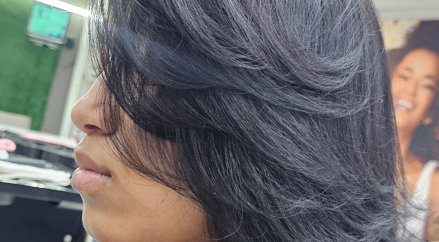 Sleek hairstyle at L and B International, Sandton, Gauteng, ZA. Perfectly styled hair emphasizing smooth texture.