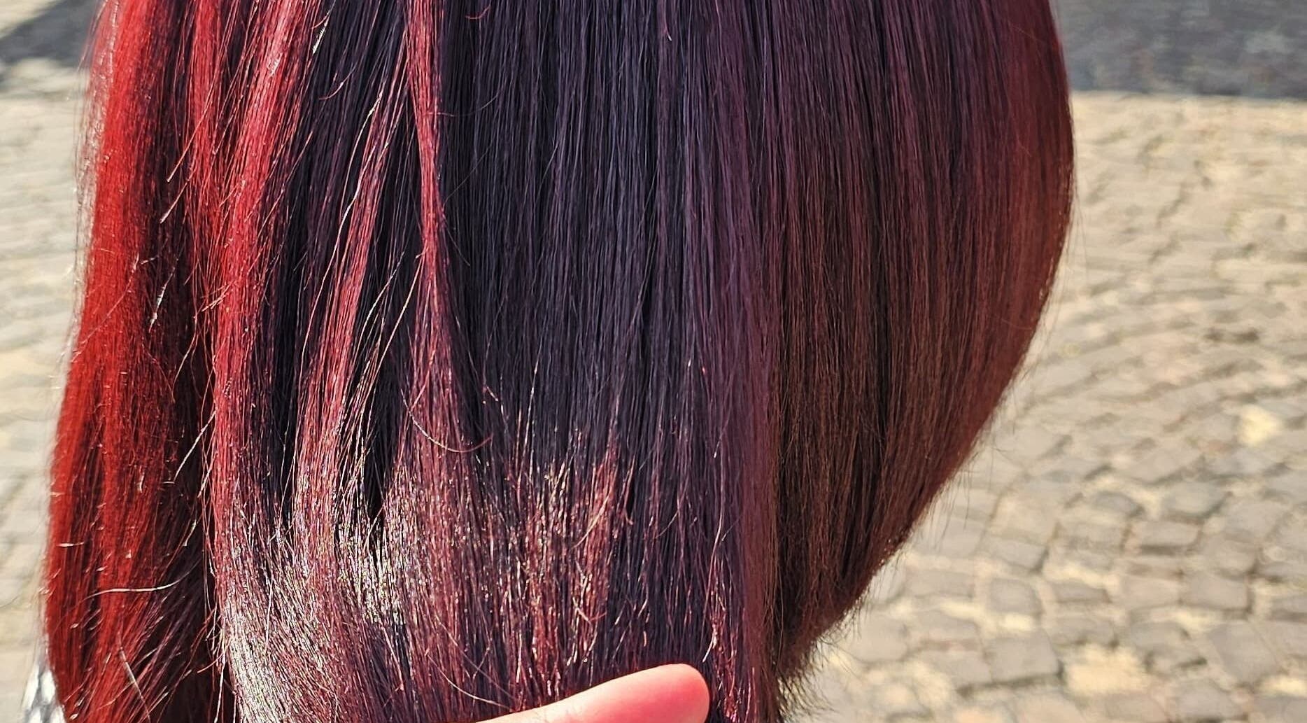 Vibrant red hair style at L and B International, Sandton, Gauteng, ZA showcasing a rich, glossy finish.