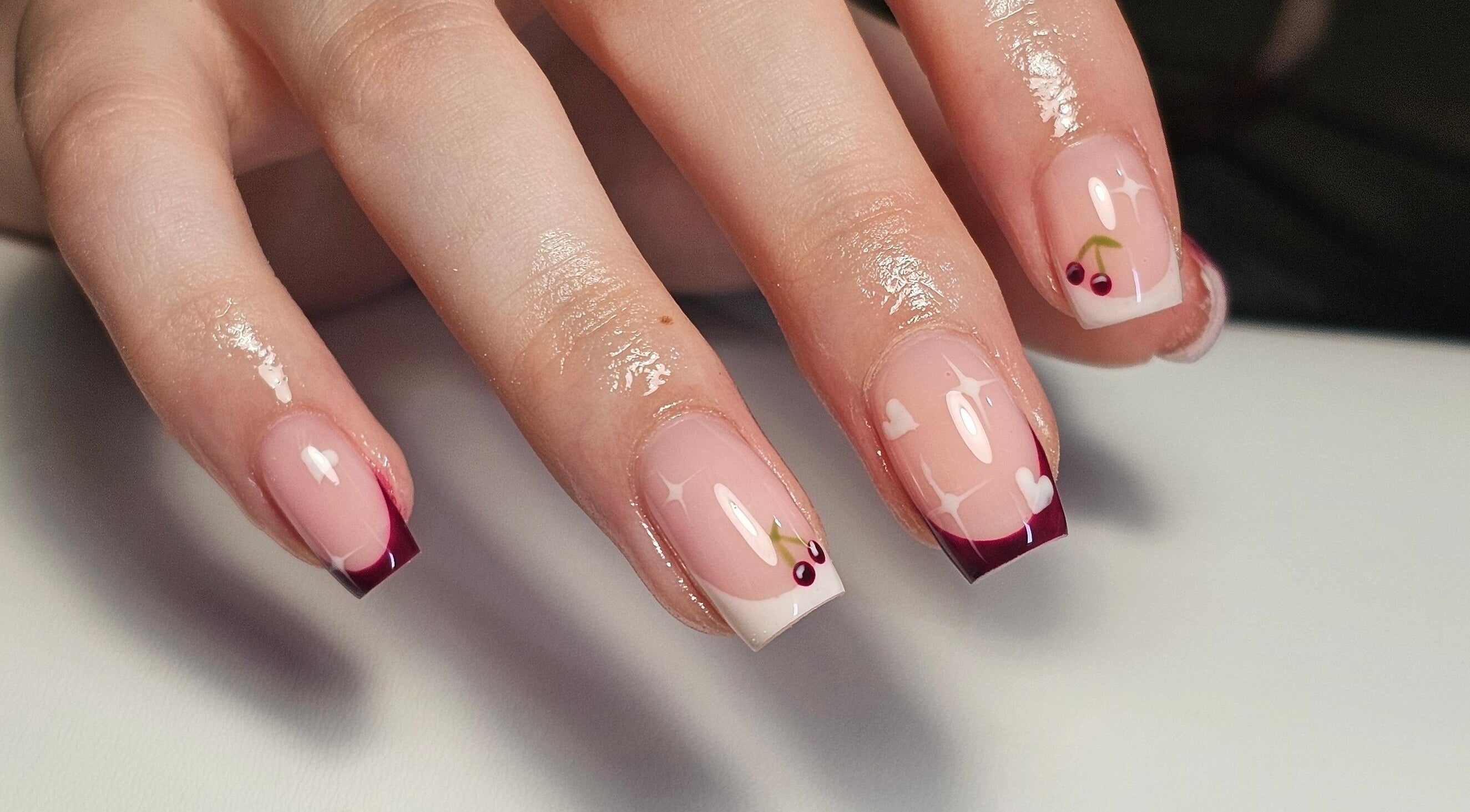 Stylish cherry-themed nail art by Nails by Alissia in Bournemouth, England, GB offering elegance and creativity.
