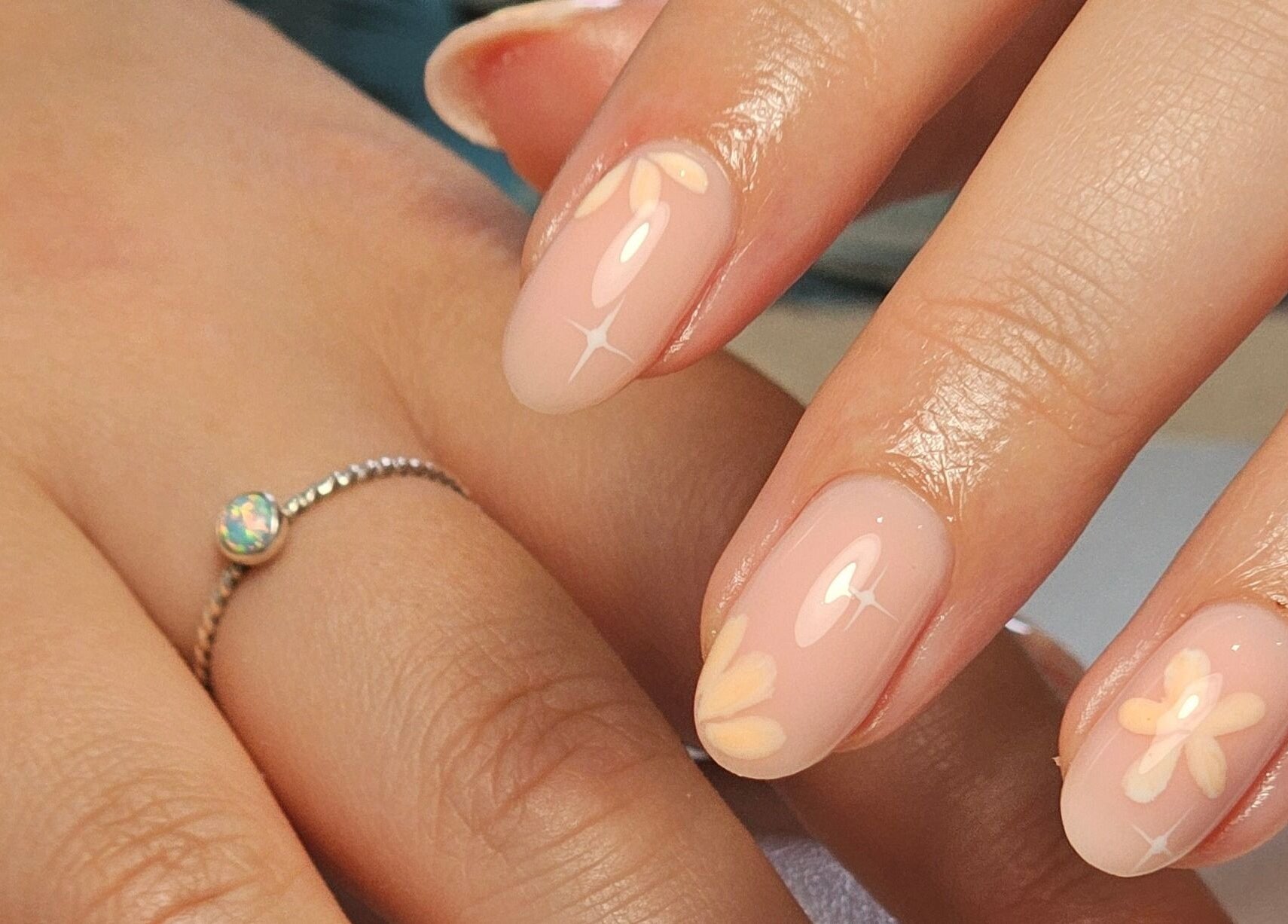 Elegant floral nail art on manicured hands at Nails by Alissia, Bournemouth, England, GB.