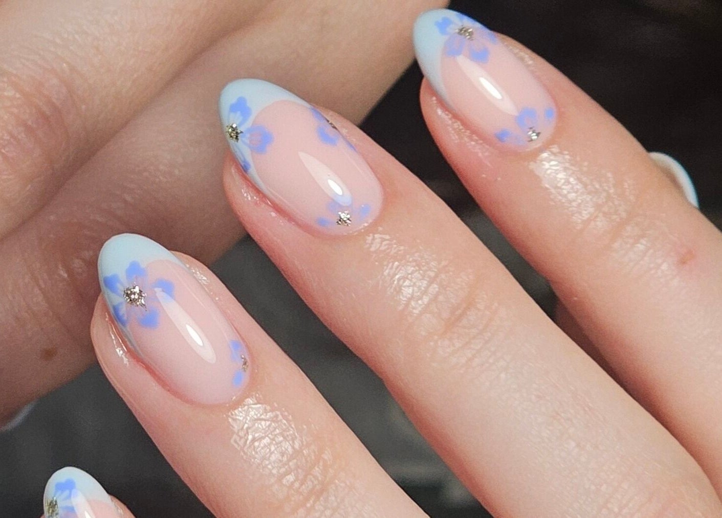 Elegant floral nail art by Nails by Alissia in Bournemouth, England, GB featuring delicate blue flowers.