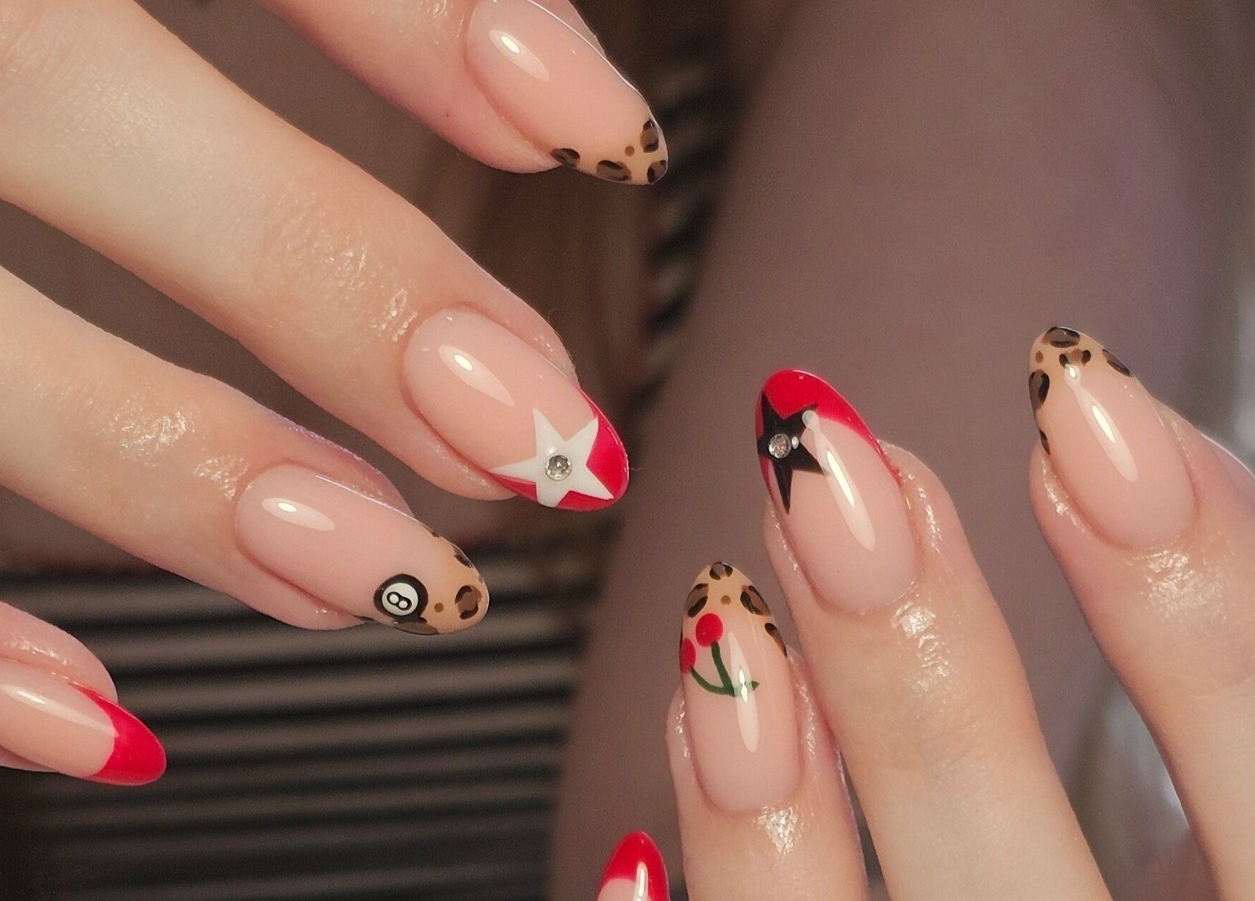 Trendy nail art designs at Nails by Alissia in Bournemouth, England, GB featuring leopard and stars.