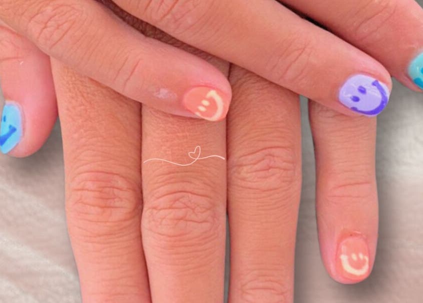 Colorful smiley nail art at Adore Nails & Massage, Bali, Bali, ID. Perfect for a cheerful, stylish look.