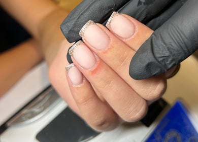 Nail artist crafting elegant French manicure at Radiance Aesthetics, Portsmouth, England, GB.