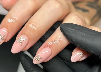 Elegant pink nails with star designs by Brook Olyvia at Radiance Aesthetics, Portsmouth, England, GB.