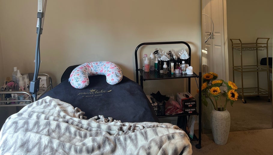 Relaxing setup at Paulina Kozyra Eyelash&Eyebrow, Loanhead, Scotland, GB with treatment bed and vibrant sunflowers.