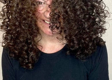 A person with voluminous curly hair smiles at Jordan Alexander @ Bathgate, Bathgate, Scotland, GB.