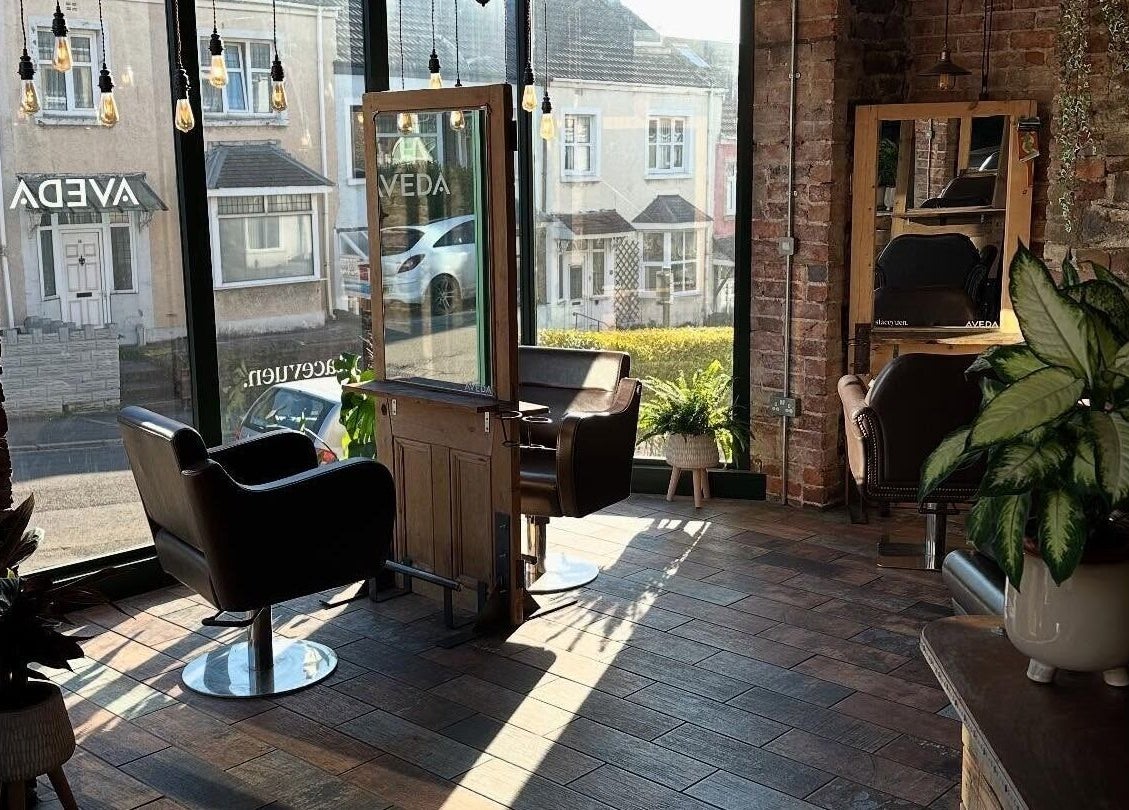 Modern salon interior with stylish chairs at Stacey Yuen Aveda Brynmill, Brynmill, Wales, GB.