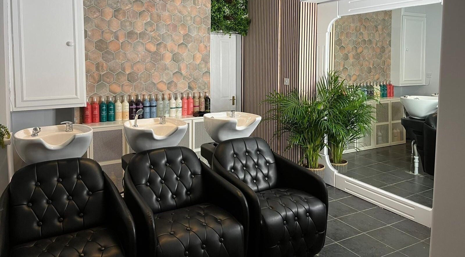 Modern salon with sleek chairs at Stacey Yuen Aveda Mumbles in Swansea, Wales, GB.