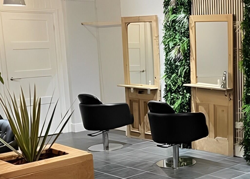 Stylish salon chairs and green decor at Stacey Yuen Aveda Mumbles, Swansea, Wales, GB.