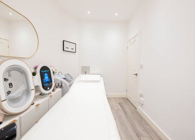 Treatment room at Oxa Beauty in London, England, GB, featuring modern equipment and calming decor.