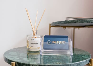 Oxa Beauty fragrance display on elegant green table in London, England, GB.