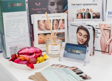 Oxa Beauty brochures and products display in London, England, GB showcasing diverse beauty services.
