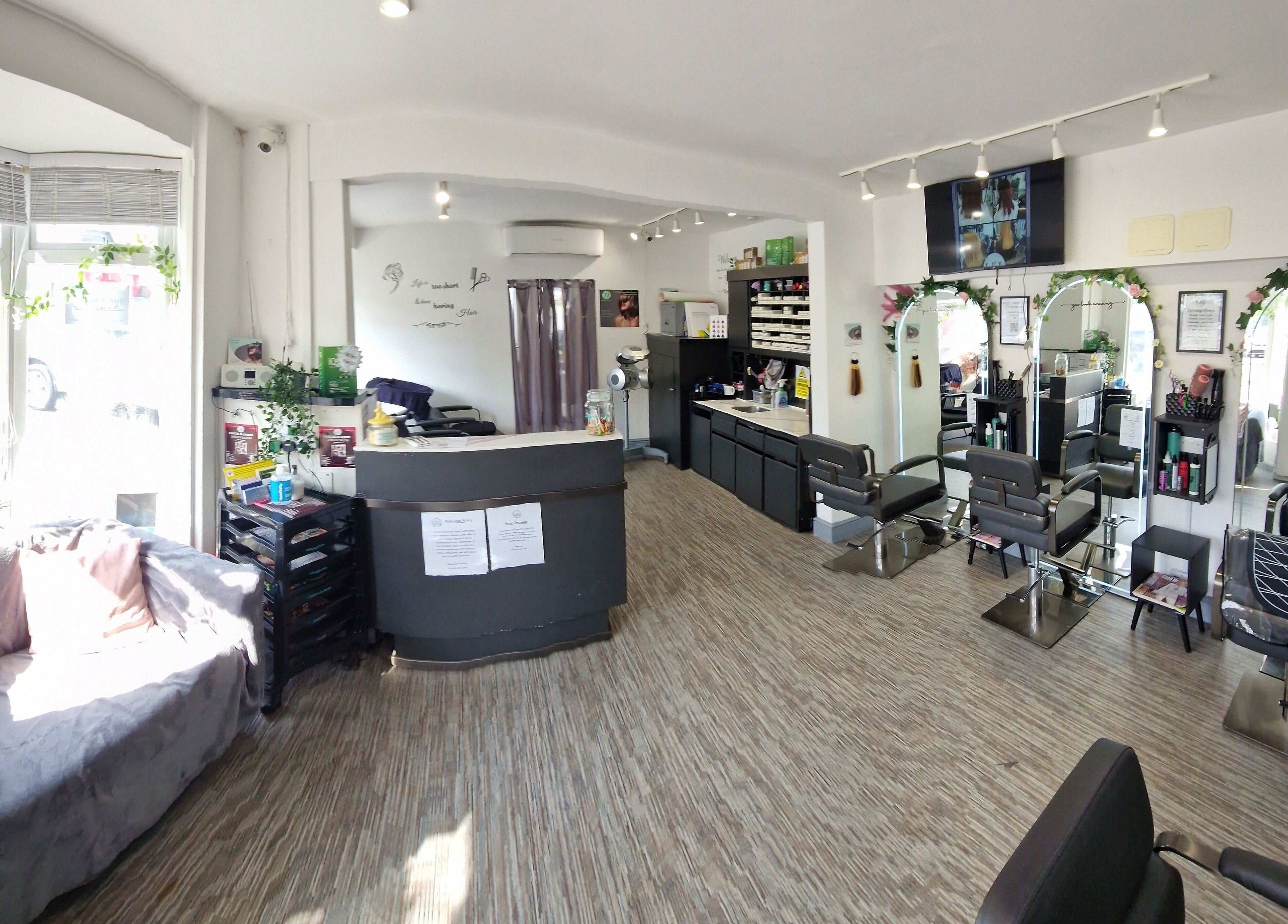 Elegant interior of Lucie And Lynn salon in High Wycombe, England showcasing modern styling stations.