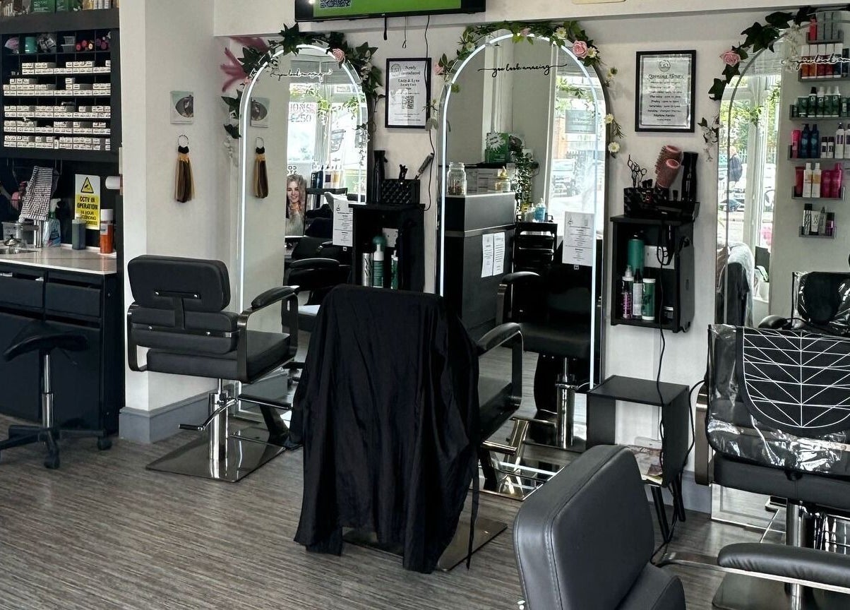Elegant salon interior at Lucie And Lynn, High Wycombe, England, GB, showcasing styling stations and mirrors.