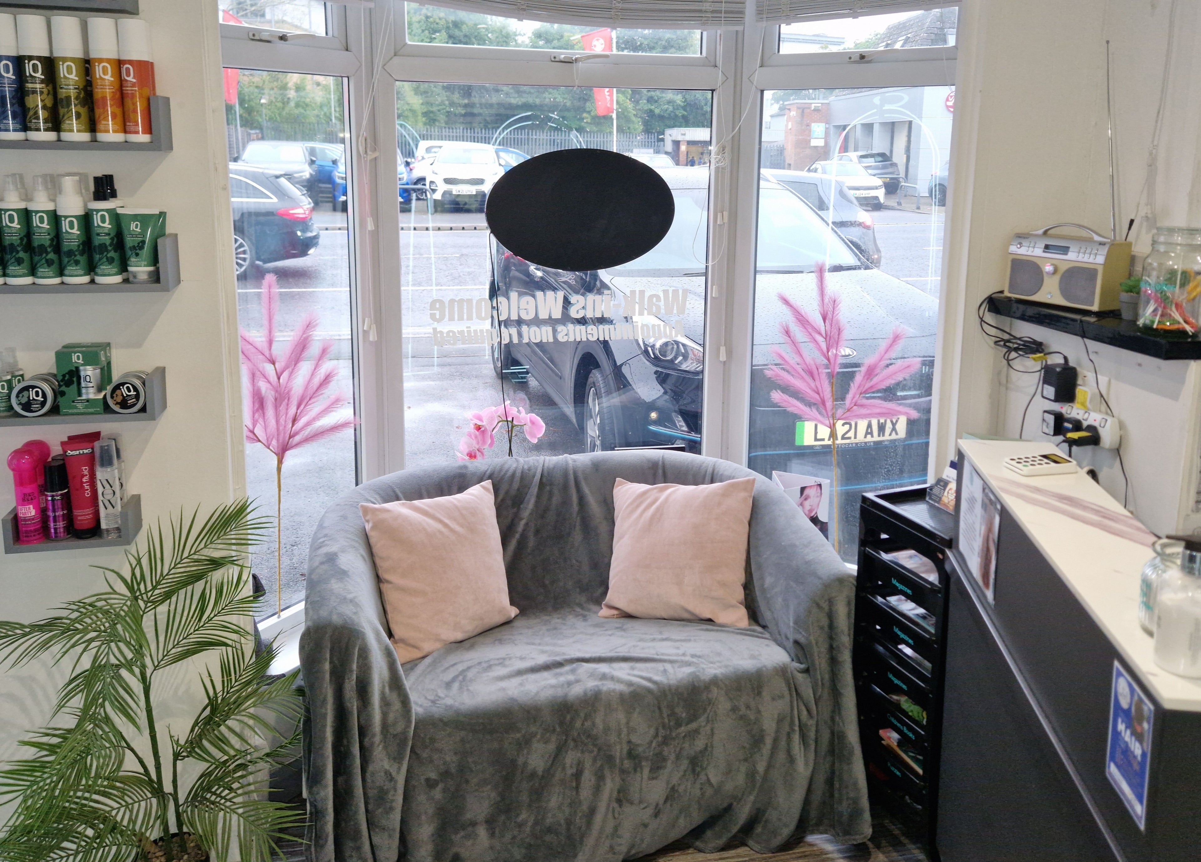 Inviting seating area in Lucie And Lynn, High Wycombe, England with plush grey sofa by a window.