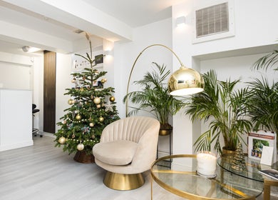 Elegant lounge at N and N Knightsbridge, London, England, GB, with festive decor and plush seating.