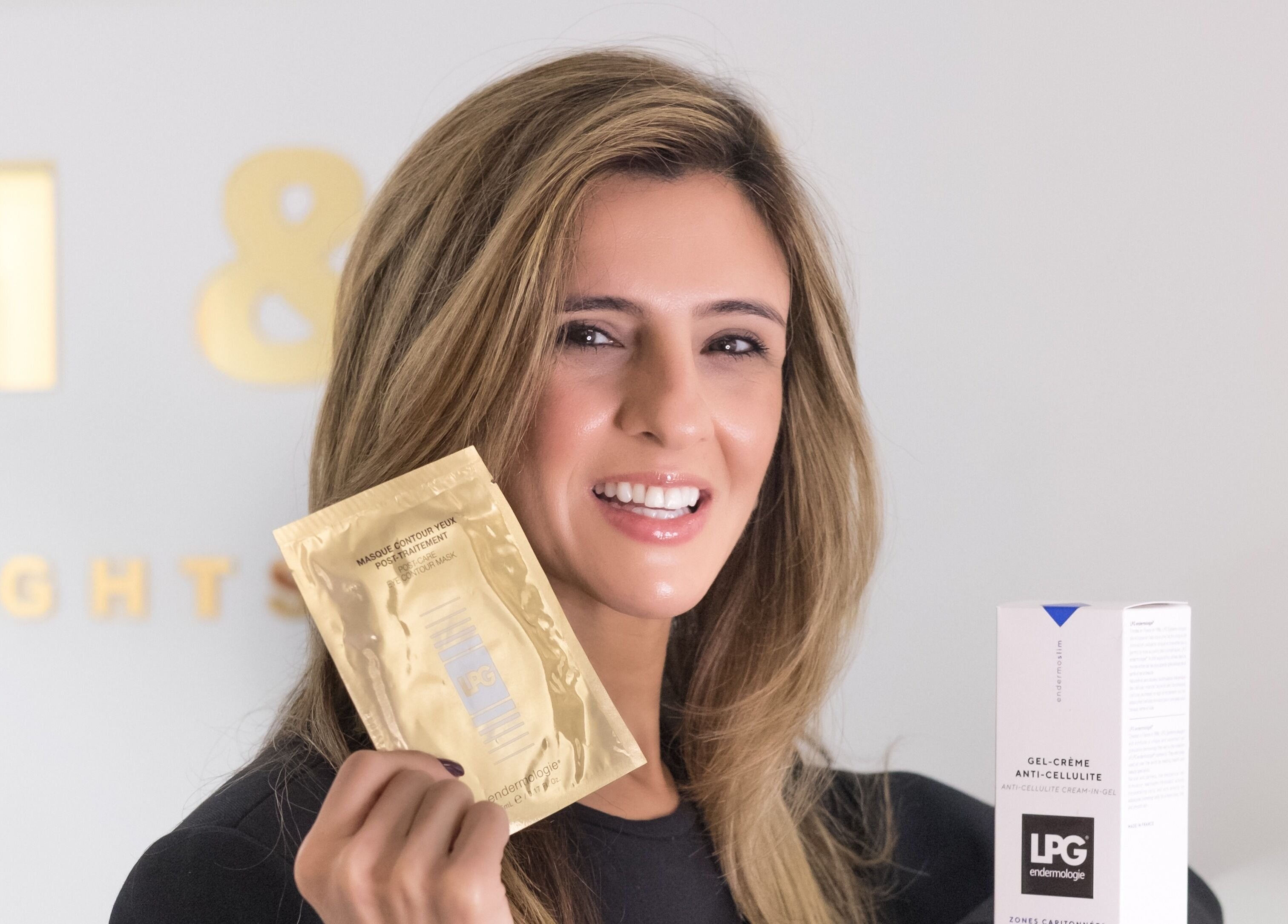 Smiling woman holding beauty products at N and N Knightsbridge, London, England, GB.