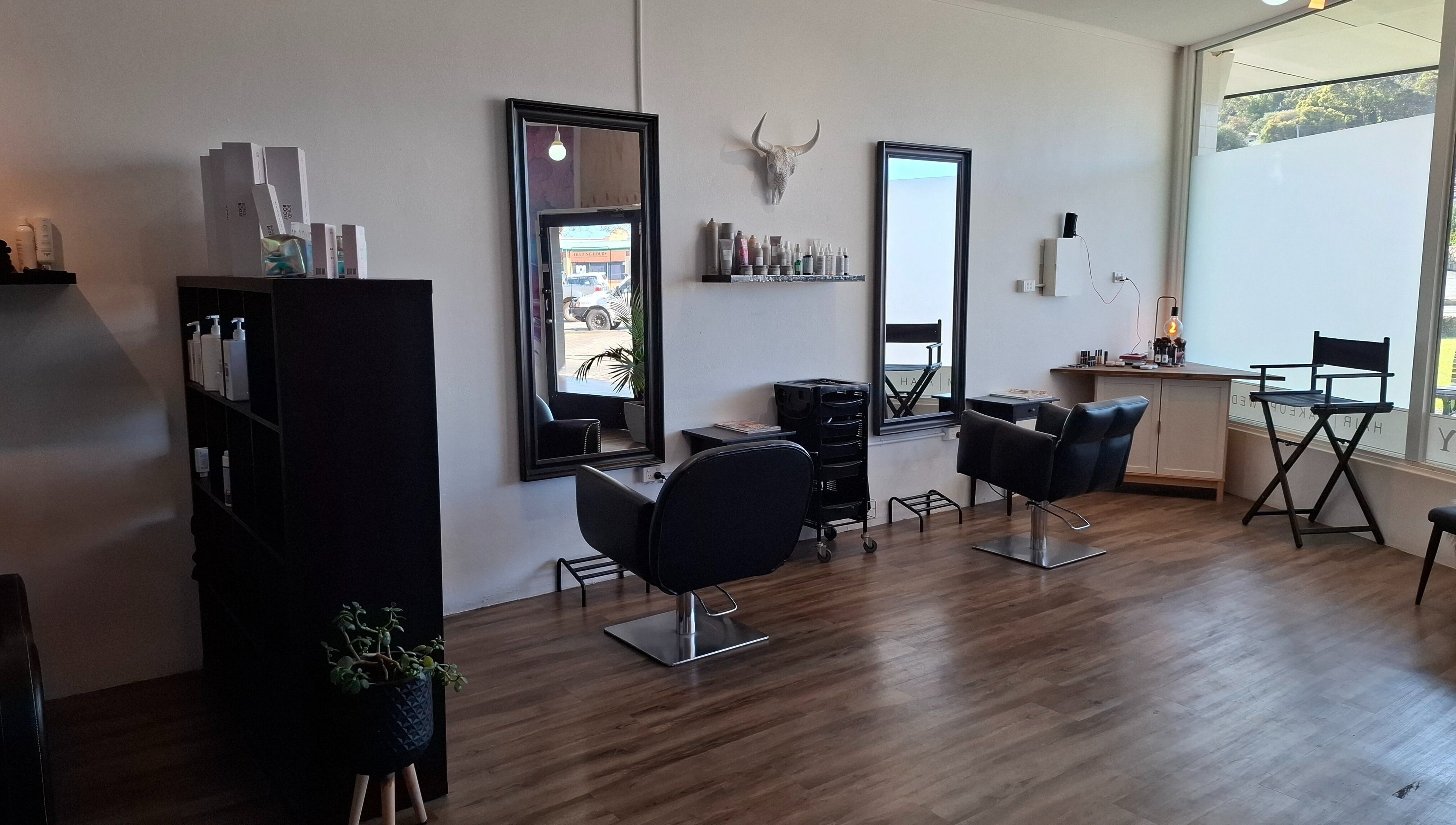 Modern salon interior at Jemma May, Albany, Western Australia, AU featuring stylish chairs and mirrors.