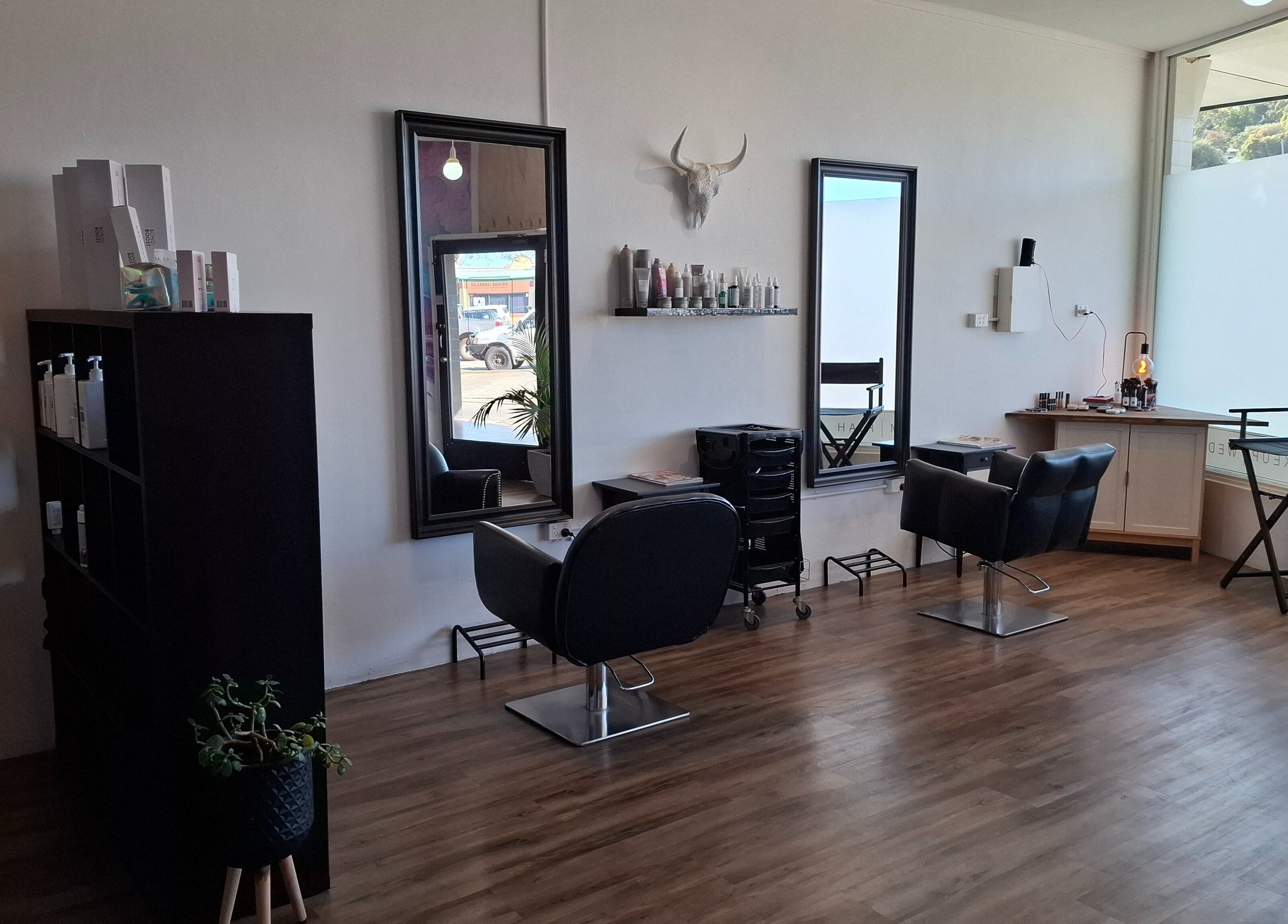 Modern salon interior at Jemma May, Albany, Western Australia, AU featuring stylish chairs and mirrors.