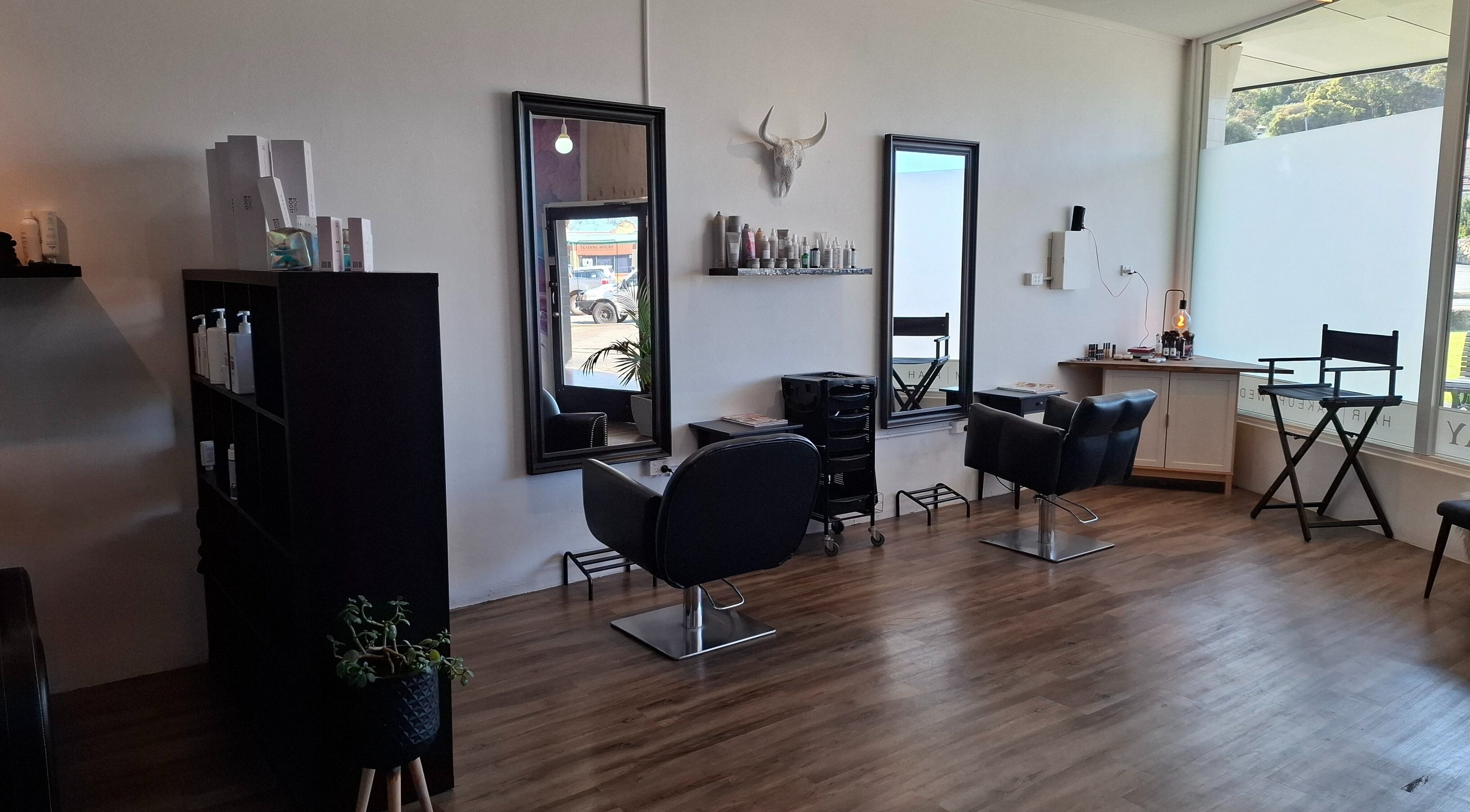 Modern salon interior at Jemma May, Albany, Western Australia, AU featuring stylish chairs and mirrors.