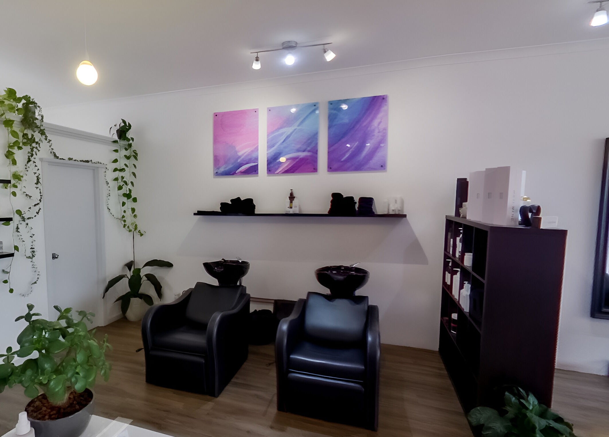 Calm salon interior at Jemma May, Albany, Western Australia, AU, with plants and artwork.