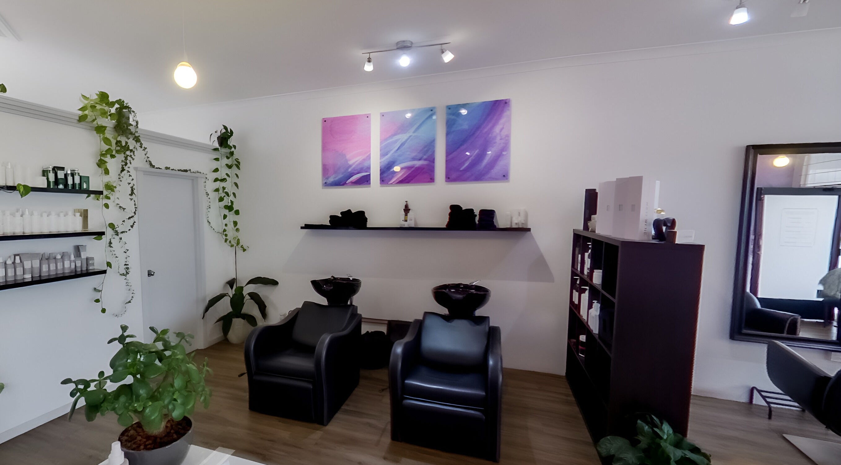 Calm salon interior at Jemma May, Albany, Western Australia, AU, with plants and artwork.