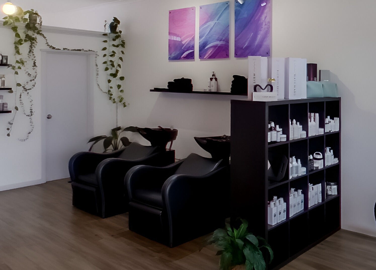 Modern interior of Jemma May in Albany, Western Australia featuring stylish salon chairs and plant decor.
