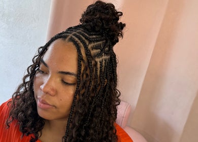 Intricate hairstyle at Glam Styles, Princess Quarter SX, featuring detailed braids and natural curls.