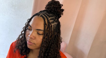 Intricate hairstyle at Glam Styles, Princess Quarter SX, featuring detailed braids and natural curls.