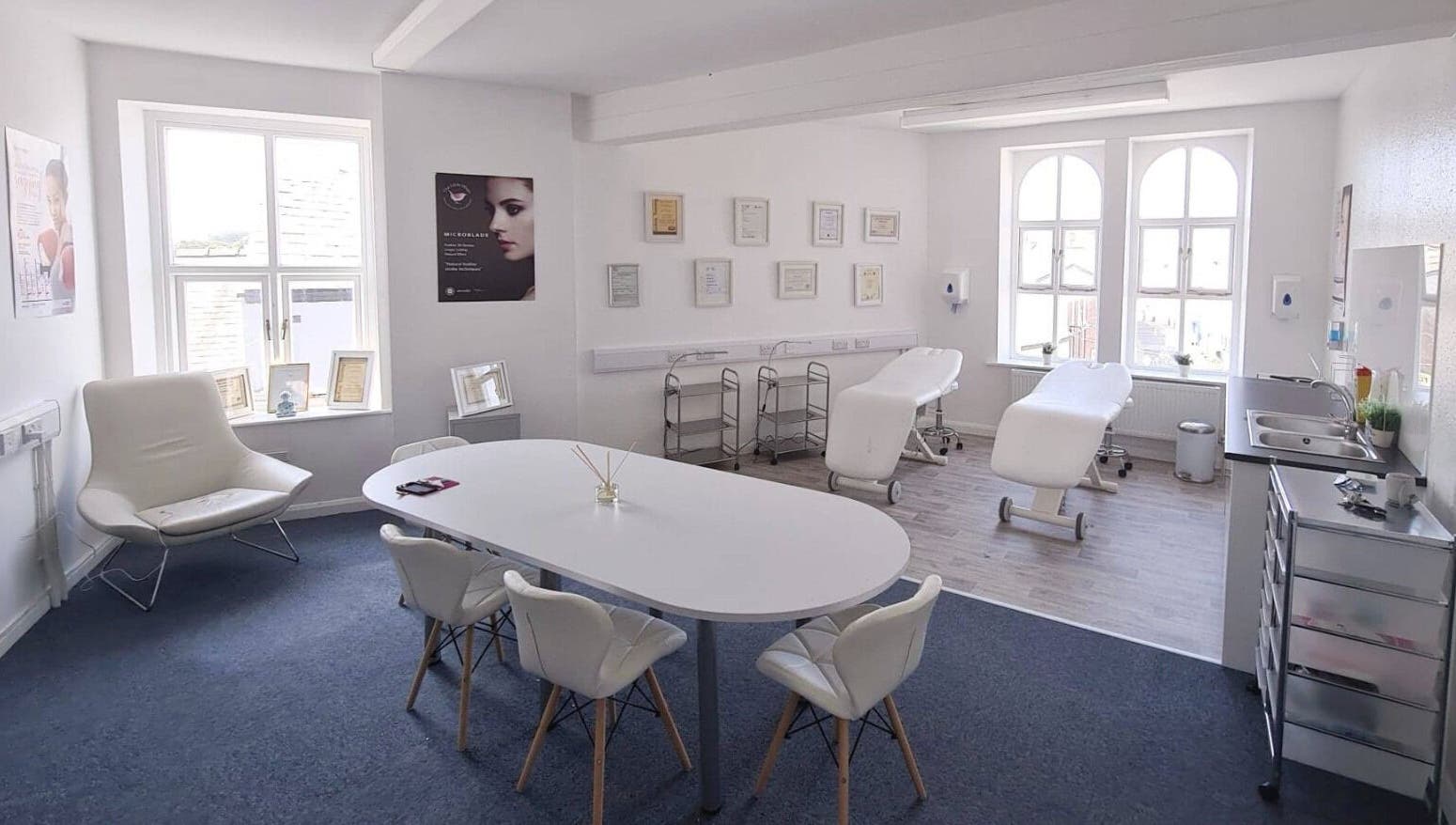 Bright therapy room at The Little Wren, Caernarfon, Wales, GB with massage tables and elegant decor.