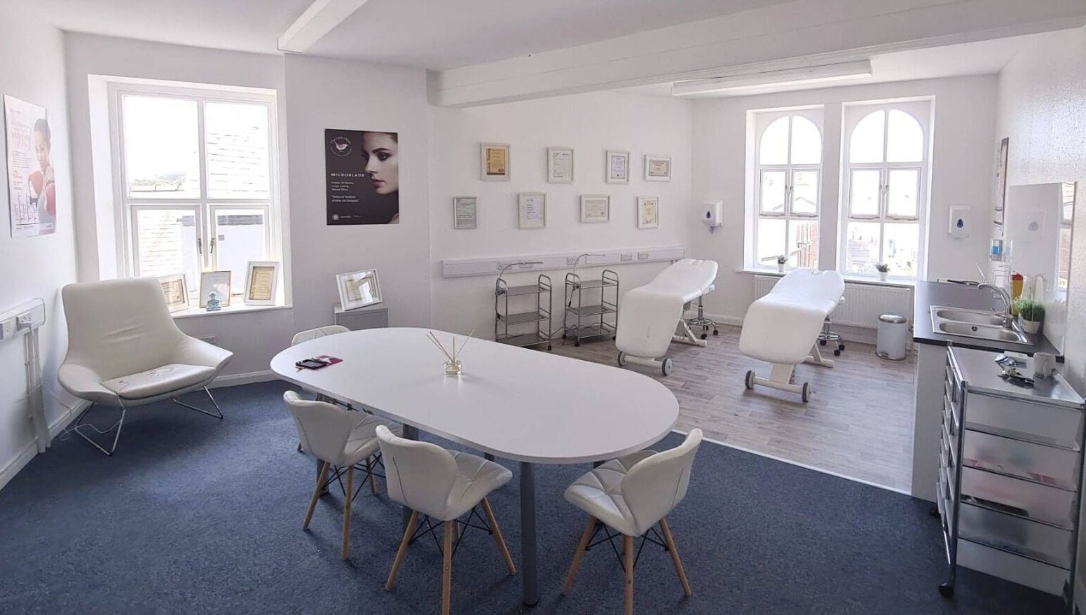 Bright therapy room at The Little Wren, Caernarfon, Wales, GB with massage tables and elegant decor.