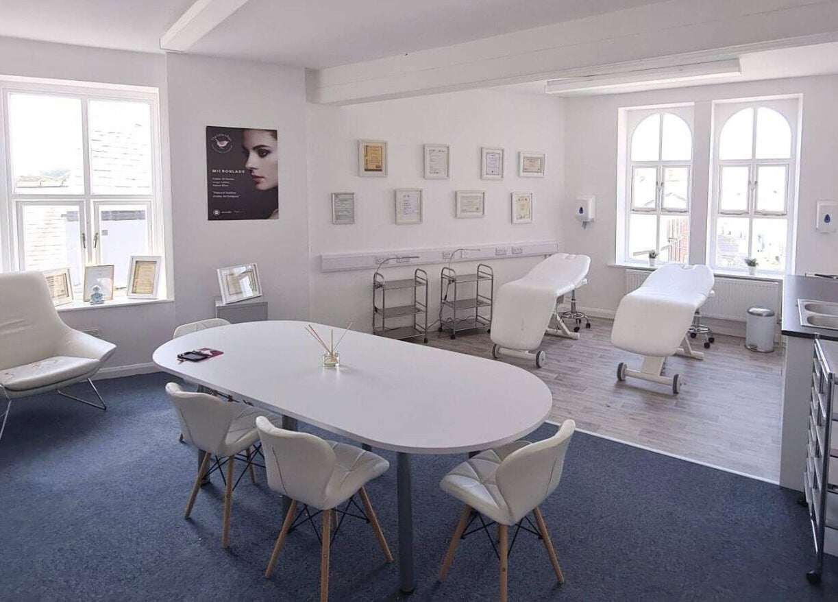 Bright therapy room at The Little Wren, Caernarfon, Wales, GB with massage tables and elegant decor.