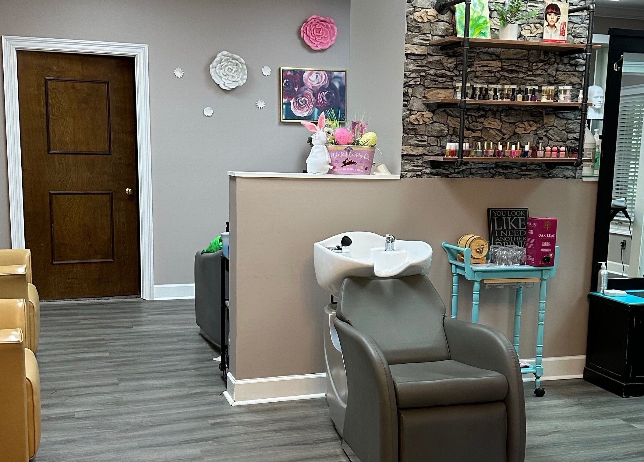 Modern interior of Studio 36 Salon and Spa, Mobile, Alabama, US showcasing wash area and nail products.