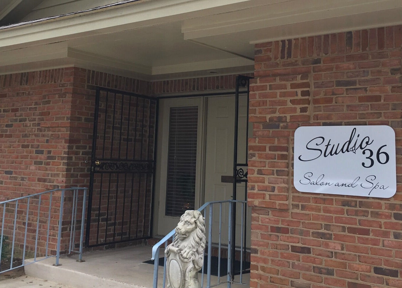 Front view of Studio 36 Salon and Spa, located in Mobile, Alabama, US, featuring a welcoming brick exterior.