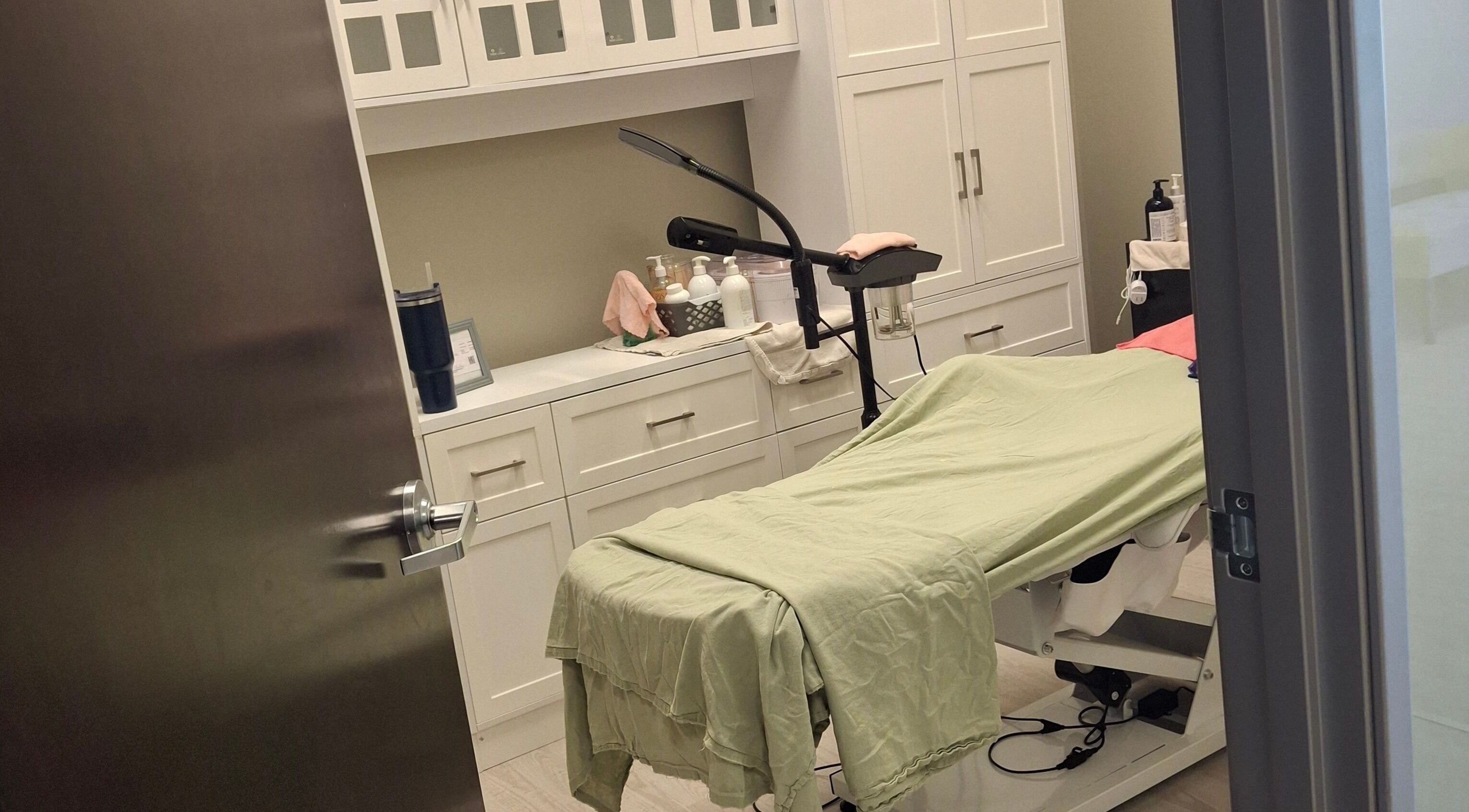 Cozy treatment room at Beautiful Rose Spa, Avondale, Arizona, US. Modern design with soft green linens.