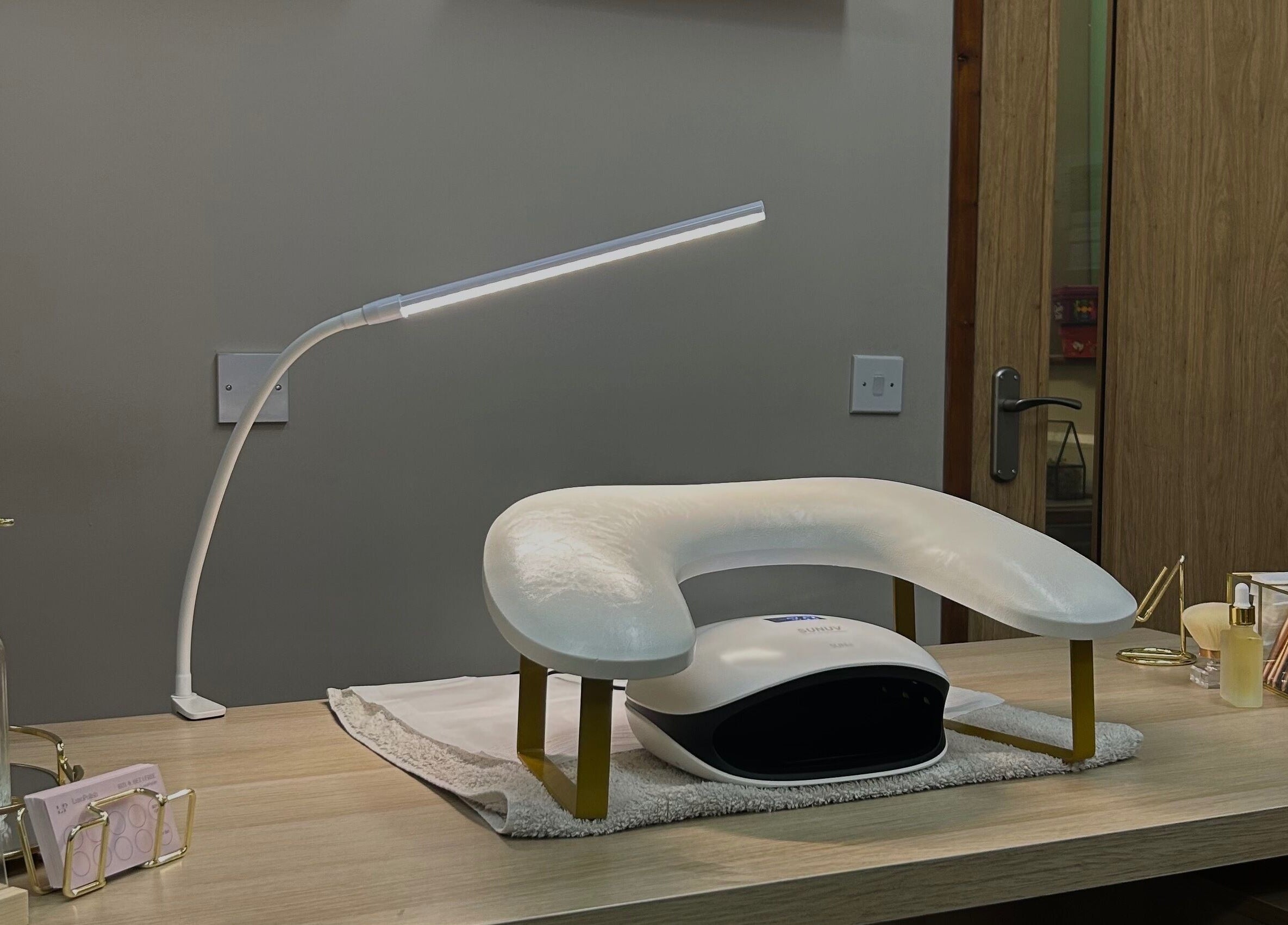 LuxoPolish nail station with manicure lamp in Castlethorpe, England, GB, offering a chic and serene ambiance.