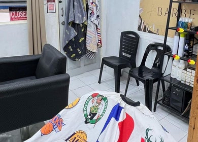 Interior of Bangcik Barber Shop in BUKIT MERTAJAM, Pulau Pinang, MY, featuring chairs and barber products.
