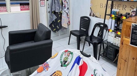 Interior of Bangcik Barber Shop in BUKIT MERTAJAM, Pulau Pinang, MY, featuring chairs and barber products.