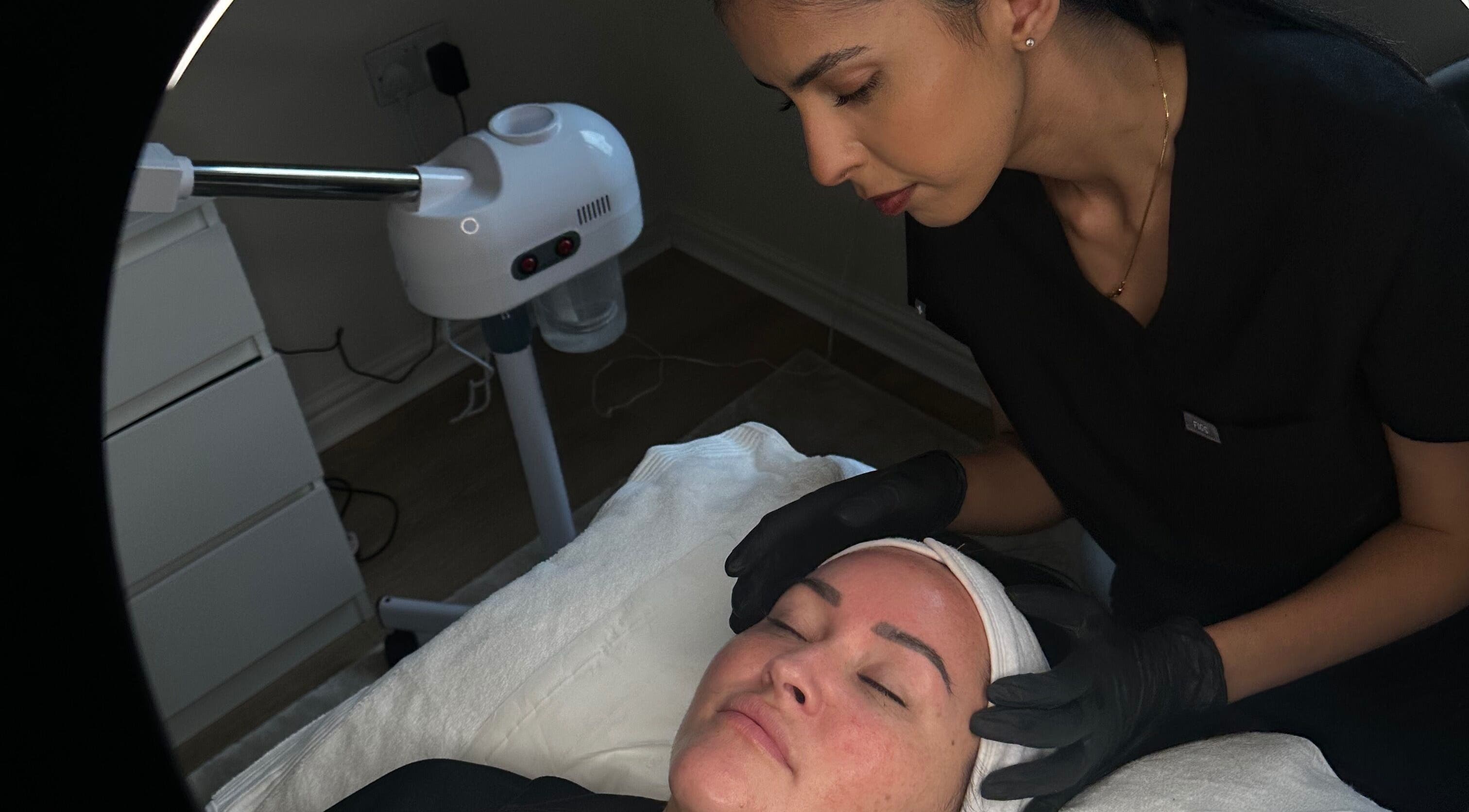 Aesthetician performing facial treatment at Glaze Skincare, Telford, England, GB.