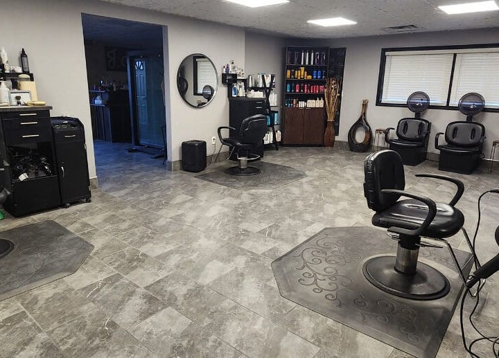 Interior of J. Cole Salon & Spa, Saylor Township, Iowa, US featuring modern styling chairs and beauty products display.
