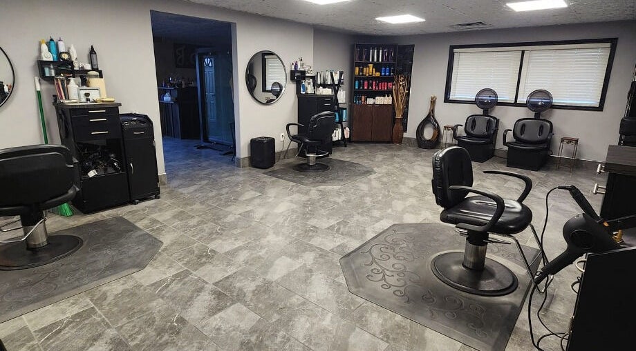 Interior of J. Cole Salon & Spa, Saylor Township, Iowa, US featuring modern styling chairs and beauty products display.