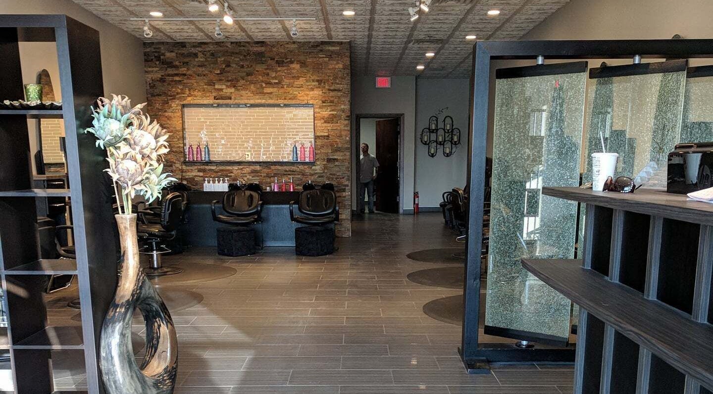 Modern interior of J. Cole Salon & Spa in Saylor Township, Iowa, featuring stylish decor and salon chairs.