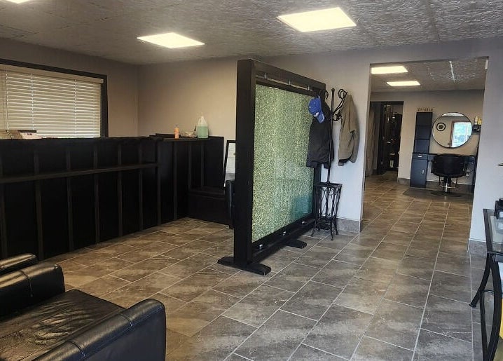 Warm waiting area at J. Cole Salon & Spa in Saylor Township, Iowa, US, featuring seating and modern decor.