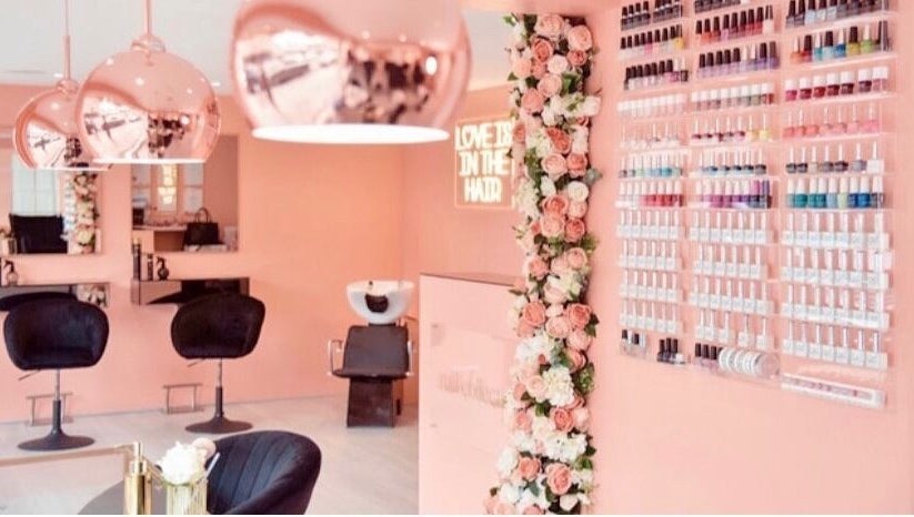 Elegant interior of Collective Beauty London in Coulsdon, England, showcasing chic decor and nail polish display.