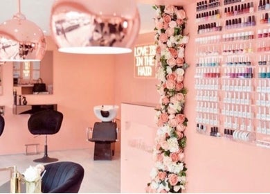 Elegant interior of Collective Beauty London in Coulsdon, England, showcasing chic decor and nail polish display.