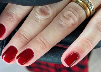 Elegant red manicure by Collective Beauty London in Coulsdon, England, GB. Perfectly polished nails in rich crimson.