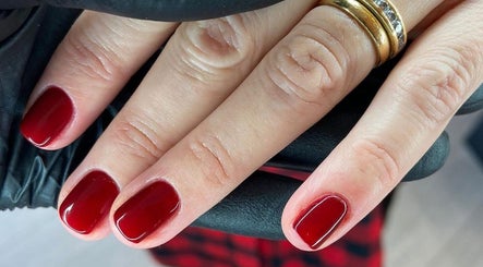 Elegant red manicure by Collective Beauty London in Coulsdon, England, GB. Perfectly polished nails in rich crimson.