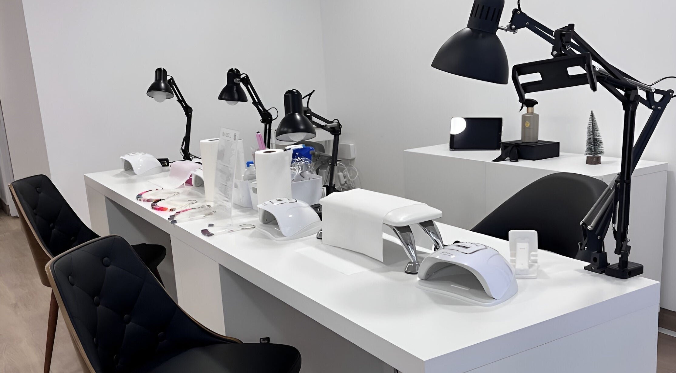 Nail station setup at Michele Furtado Beauty, Lisboa, Lisboa, PT. Features tools and chairs in a sleek design.